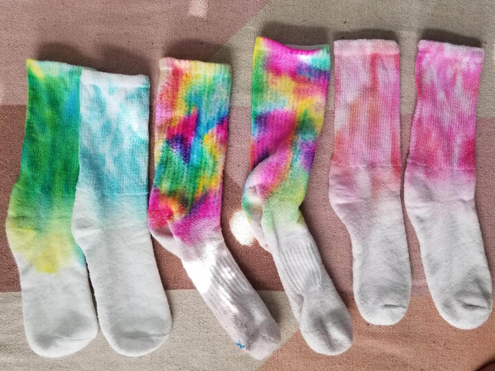 Image of tie-dyed socks to encourage tick safety. 